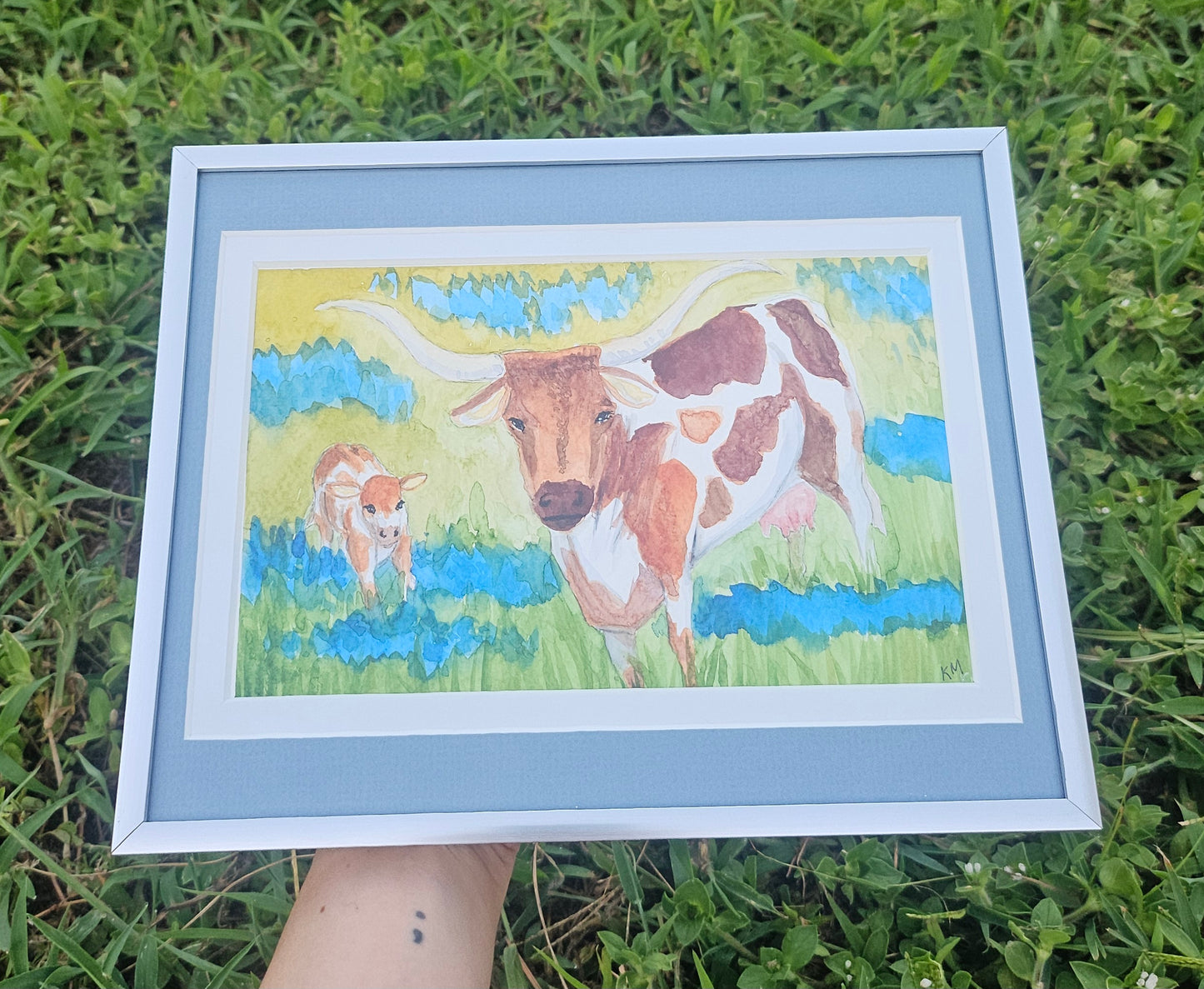 Longhorns and Blue Bonnets framed water